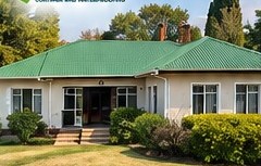 Freshly painted home with recoated green roof in Standerton